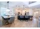 Open-plan kitchen and dining area with island seating and modern light fixtures at 2695 Plume Rd, Clermont, FL 34711