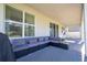 Covered patio with sectional sofa and backyard view at 2695 Plume Rd, Clermont, FL 34711