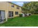 Spacious backyard with grassy area and sliding glass door access at 3006 Seaview Castle Dr, Kissimmee, FL 34746