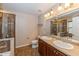 Bathroom with double vanity, shower, and tile flooring at 3006 Seaview Castle Dr, Kissimmee, FL 34746