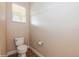 Simple toilet and wall-mounted toilet paper holder at 3006 Seaview Castle Dr, Kissimmee, FL 34746