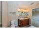 Bathroom with double vanity, toilet and access to bedroom at 3006 Seaview Castle Dr, Kissimmee, FL 34746