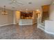Open concept kitchen and living area with staircase at 3006 Seaview Castle Dr, Kissimmee, FL 34746