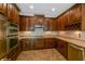 Modern kitchen with dark wood cabinets and a wine rack at 3006 Seaview Castle Dr, Kissimmee, FL 34746