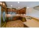 Well-equipped kitchen with dark wood cabinets and granite countertops at 3006 Seaview Castle Dr, Kissimmee, FL 34746