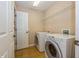 Laundry room with washer, dryer and shelving at 3006 Seaview Castle Dr, Kissimmee, FL 34746