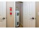 Utility closet with water heater and fire extinguisher at 3006 Seaview Castle Dr, Kissimmee, FL 34746