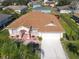 Aerial view of single-Gathering home with driveway and landscaped yard at 552 Eagle Ct, Poinciana, FL 34759