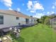 Backyard with patio, grassy area, and wooden structure at 552 Eagle Ct, Poinciana, FL 34759