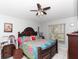 Spacious bedroom with a king-size bed and wood furniture at 552 Eagle Ct, Poinciana, FL 34759