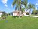 Well-maintained house with a green lawn and palm trees at 552 Eagle Ct, Kissimmee, FL 34759