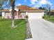 Single-story home with attached garage and manicured lawn at 552 Eagle Ct, Poinciana, FL 34759