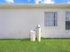 Home exterior featuring water softener system and well maintained lawn at 552 Eagle Ct, Kissimmee, FL 34759