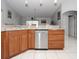 Kitchen island with stainless steel dishwasher and wood cabinets at 552 Eagle Ct, Poinciana, FL 34759