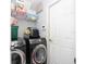 Laundry room with washer, dryer, and shelving for storage at 552 Eagle Ct, Poinciana, FL 34759