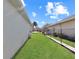 Side yard with grassy area and chain link fence at 552 Eagle Ct, Poinciana, FL 34759