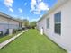 Side yard with grassy area and chain link fence at 552 Eagle Ct, Poinciana, FL 34759