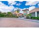 Community center entrance with landscaping and paved circular driveway at 8956 Hilton Ridge Ave, Kissimmee, FL 34747