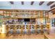 Community bar with gold barstools and a modern back bar display at 8956 Hilton Ridge Ave, Kissimmee, FL 34747
