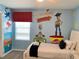 Toy Story themed bedroom with twin bed and fun wall art at 8956 Hilton Ridge Ave, Kissimmee, FL 34747