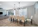 Elegant dining room with large glass table and modern chandelier at 8956 Hilton Ridge Ave, Kissimmee, FL 34747