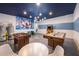Basement game room with air hockey, foosball, and Marvel mural at 8956 Hilton Ridge Ave, Kissimmee, FL 34747