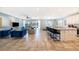 Open concept kitchen with white cabinets, large island, and dining area at 8956 Hilton Ridge Ave, Kissimmee, FL 34747