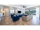 Bright living room with a sectional sofa, blue armchairs, and sliding doors to the pool at 8956 Hilton Ridge Ave, Kissimmee, FL 34747