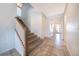 Modern staircase with wood railing and carpeted steps at 8956 Hilton Ridge Ave, Kissimmee, FL 34747