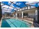 Spacious pool area with covered patio and hot tub at 8956 Hilton Ridge Ave, Kissimmee, FL 34747