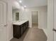 Double vanity bathroom with dark brown cabinets and a large mirror at 127 Hickory Crse, Ocala, FL 34472