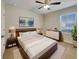Bright bedroom with a queen bed, dresser, and ceiling fan at 127 Hickory Crse, Ocala, FL 34472