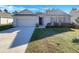 One-story home with gray siding, a two-car garage, and a well-manicured lawn at 127 Hickory Crse, Ocala, FL 34472