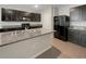 Modern kitchen with dark cabinetry, granite countertops, and stainless steel appliances at 127 Hickory Crse, Ocala, FL 34472