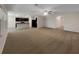 Open concept living room and kitchen with neutral color palette and carpeted floors at 127 Hickory Crse, Ocala, FL 34472