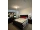 Spacious bedroom with a king-size bed and dark brown furniture at 16344 Blooming Cherry Dr, Groveland, FL 34736