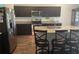Kitchen with dark cabinetry, granite countertops, and stainless steel appliances at 16344 Blooming Cherry Dr, Groveland, FL 34736