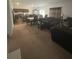 Open living and dining area with neutral carpeting and ample natural light at 16344 Blooming Cherry Dr, Groveland, FL 34736