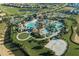 Aerial view of community pool, clubhouse, and surrounding landscape at 1680 Moon Valley Dr, Davenport, FL 33896