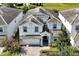 Two-story house, gray roof, white exterior, and a paved driveway at 1680 Moon Valley Dr, Davenport, FL 33896