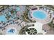 Community pool area with multiple pools, lounge chairs, and a playground at 1680 Moon Valley Dr, Davenport, FL 33896