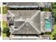Home with dark gray tile roof and screened pool in backyard at 1680 Moon Valley Dr, Davenport, FL 33896