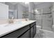 Modern bathroom with double vanity, large shower, and marble tile at 1680 Moon Valley Dr, Davenport, FL 33896