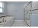 Bathroom with soaking tub and walk-in shower at 1680 Moon Valley Dr, Davenport, FL 33896