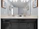 Modern bathroom with double vanity and a large mirror at 1680 Moon Valley Dr, Davenport, FL 33896