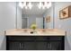 Bathroom with double vanity, granite countertop, and dark cabinets at 1680 Moon Valley Dr, Davenport, FL 33896