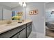 Bathroom with double vanity, granite countertop, and dark cabinets at 1680 Moon Valley Dr, Davenport, FL 33896