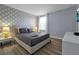 Bedroom with a king-size bed and geometric patterned wall at 1680 Moon Valley Dr, Davenport, FL 33896