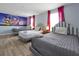 Bedroom with three twin beds, themed decor, and wood-look floors at 1680 Moon Valley Dr, Davenport, FL 33896