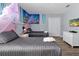 Bedroom with two twin beds, themed decor, and wood-look floors at 1680 Moon Valley Dr, Davenport, FL 33896